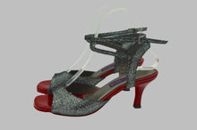 Red dancing shoes, black and shiny dancing shoes with red heel.